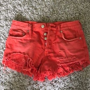 Red distressed jean shorts